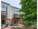 View of the back exterior of townhomes with decks and patios at 4933 Wyatt Brook Way, Raleigh, NC 27609