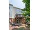 View of the back exterior with the raised wooden deck and ground level patio at 4933 Wyatt Brook Way, Raleigh, NC 27609