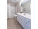 Functional bathroom featuring white cabinets, a tub with shower, and coordinated tile flooring at 4933 Wyatt Brook Way, Raleigh, NC 27609