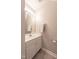 Neat half bathroom featuring a white vanity, a mirror, and well-kept tile flooring at 4933 Wyatt Brook Way, Raleigh, NC 27609