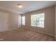 Well-lit bedroom featuring carpet flooring, a large window with blinds, and neutral wall color at 4933 Wyatt Brook Way, Raleigh, NC 27609