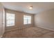 Spacious bedroom with plush carpet, natural light from the windows, and neutral paint at 4933 Wyatt Brook Way, Raleigh, NC 27609