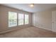 Bright bedroom boasts plush carpet, natural light, and a closet at 4933 Wyatt Brook Way, Raleigh, NC 27609