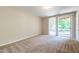 Spacious bedroom with neutral carpet and sliding glass doors leading to the backyard at 4933 Wyatt Brook Way, Raleigh, NC 27609