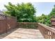 Exterior wooden deck surrounded by lush trees offering privacy and outdoor space at 4933 Wyatt Brook Way, Raleigh, NC 27609