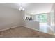 Open floor plan with plush carpeting leads to the kitchen with granite countertops at 4933 Wyatt Brook Way, Raleigh, NC 27609