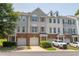 Charming townhome exteriors with brick accents, inviting garages, and neatly manicured landscaping at 4933 Wyatt Brook Way, Raleigh, NC 27609