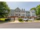 A street view capturing multiple townhomes, each featuring brick facades and attached garages at 4933 Wyatt Brook Way, Raleigh, NC 27609