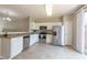 Bright kitchen features white cabinets, stainless steel appliances, and sliding door to the exterior at 4933 Wyatt Brook Way, Raleigh, NC 27609
