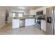 Stylish kitchen with stainless steel appliances and granite countertops, with an open view to the dining area at 4933 Wyatt Brook Way, Raleigh, NC 27609