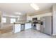 Bright kitchen features white cabinets and stainless steel appliances overlooking an open-concept living space at 4933 Wyatt Brook Way, Raleigh, NC 27609
