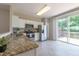 Modern kitchen with stainless steel appliances, light cabinets, granite countertops, and access to a deck at 4933 Wyatt Brook Way, Raleigh, NC 27609
