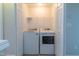 Convenient laundry room equipped with a washer, dryer, and upper shelving at 4933 Wyatt Brook Way, Raleigh, NC 27609
