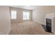 Living room with plush carpeting, a fireplace, and natural light from the many windows at 4933 Wyatt Brook Way, Raleigh, NC 27609