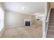 Bright living room with carpet and fireplace, flowing into adjacent kitchen with stainless steel appliances at 4933 Wyatt Brook Way, Raleigh, NC 27609