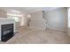 Cozy living room with plush carpeting and a classic fireplace, perfect for relaxation and gatherings at 4933 Wyatt Brook Way, Raleigh, NC 27609
