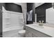 Bathroom showcases a white shower and tub combo, grey cabinets, and a white countertop with stainless steel fixtures at 512 Providence Springs Ln, Fuquay Varina, NC 27526