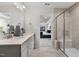 This bathroom features a shower with a glass enclosure, a double sink, and is connected to the main bedroom at 512 Providence Springs Ln, Fuquay Varina, NC 27526
