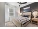 Bedroom featuring a bed with a light-colored wooden frame, dark accent wall and a side table with mirror and lamp at 512 Providence Springs Ln, Fuquay Varina, NC 27526