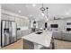 Open-concept kitchen with a large island, modern appliances, and stylish pendant lighting at 512 Providence Springs Ln, Fuquay Varina, NC 27526