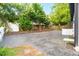 Spacious backyard features gravel ground cover, mature trees, and fenced perimeter at 516 Ottawa Ave, Durham, NC 27701