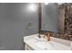 Stylish half-bathroom with floral wallpaper, elegant gold fixtures and marble countertop at 516 Ottawa Ave, Durham, NC 27701