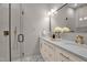 Modern bathroom with double vanity, elegant gold fixtures, and a glass shower at 516 Ottawa Ave, Durham, NC 27701