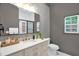 Bathroom boasts stylish wallpaper, a marble countertop vanity, and modern fixtures at 516 Ottawa Ave, Durham, NC 27701