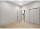 Bedroom showcasing a closet and doorway to the bathroom with hardwood floors and neutral paint at 516 Ottawa Ave, Durham, NC 27701