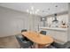 Dining area flows into a kitchen with pendant lighting and an island; a perfect blend of style and function at 516 Ottawa Ave, Durham, NC 27701