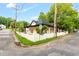 Corner lot featuring a renovated home with a white picket fence, lush landscaping, and charming curb appeal at 516 Ottawa Ave, Durham, NC 27701