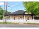 Charming single-story home with a black roof, white siding, picket fence, and inviting front porch at 516 Ottawa Ave, Durham, NC 27701