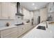 Bright kitchen with an island cooktop and stainless steel hood, along with white marble countertops at 516 Ottawa Ave, Durham, NC 27701