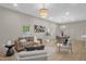 Open living room with hardwood floors, contemporary decor, and abundant natural light from multiple windows at 516 Ottawa Ave, Durham, NC 27701