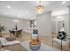 Open-concept living space with a dining area featuring modern lighting and hardwood floors throughout at 516 Ottawa Ave, Durham, NC 27701