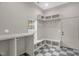 A bright mudroom features checkered floors, built-in bench seating and hooks for storage at 516 Ottawa Ave, Durham, NC 27701