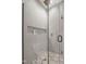 A modern shower features gray tile, a glass door and mosaic-patterned floors at 516 Ottawa Ave, Durham, NC 27701