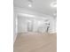 Open concept living room with modern flooring and bright white walls and a view into the kitchen at 528 Providence Springs Ln, Fuquay Varina, NC 27526