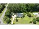 Lush landscaping and mature trees surround this two story home with a backyard pool and detached garage at 5301 Night Heron Dr, Wake Forest, NC 27587