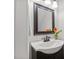 Powder room features a single sink, vanity, decorative mirror, and modern faucet at 5301 Night Heron Dr, Wake Forest, NC 27587