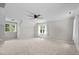 Bright bedroom with neutral carpet, ceiling fan, and windows providing ample natural light at 5301 Night Heron Dr, Wake Forest, NC 27587