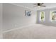 Spacious bedroom with carpet, two windows and a ceiling fan at 5301 Night Heron Dr, Wake Forest, NC 27587