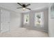Bright bedroom with two windows, ceiling fan and neutral carpet and paint at 5301 Night Heron Dr, Wake Forest, NC 27587
