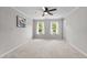 Bright bedroom with two windows, ceiling fan and neutral carpet and paint at 5301 Night Heron Dr, Wake Forest, NC 27587