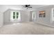Bright bedroom with three windows, ceiling fan and neutral carpet and paint at 5301 Night Heron Dr, Wake Forest, NC 27587