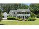 Charming two-story home with a landscaped lawn, dormer windows, and black shutters at 5301 Night Heron Dr, Wake Forest, NC 27587