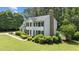 Side view of a two-story home featuring manicured landscaping, a chimney, and a glimpse of a backyard pool at 5301 Night Heron Dr, Wake Forest, NC 27587