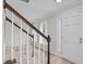 Foyer with staircase with newel post, hardwood flooring and a bright front door at 5301 Night Heron Dr, Wake Forest, NC 27587