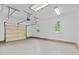 A spacious, well-lit garage with a white door and painted brick accents around the perimeter at 5301 Night Heron Dr, Wake Forest, NC 27587