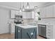 Kitchen featuring stainless appliances, bright white cabinets, an island and stylish pendant lighting at 5301 Night Heron Dr, Wake Forest, NC 27587